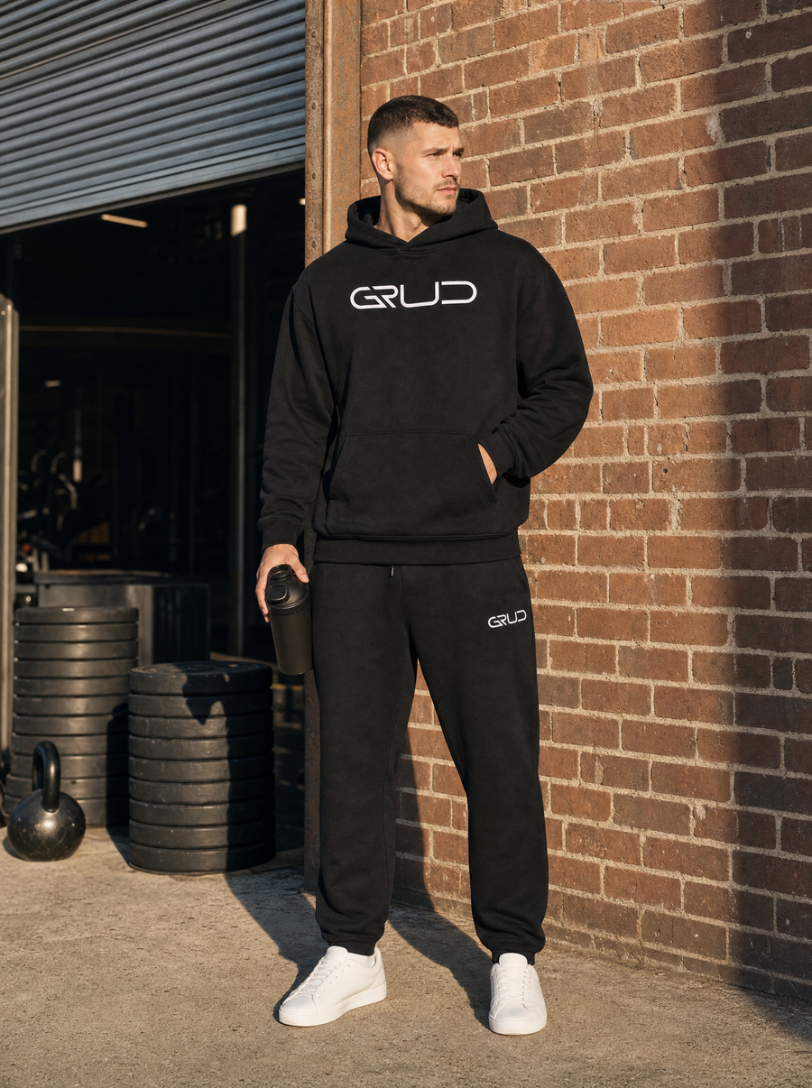 Man in the GRUD hoodie and sweat pants outside a warehouse gym
