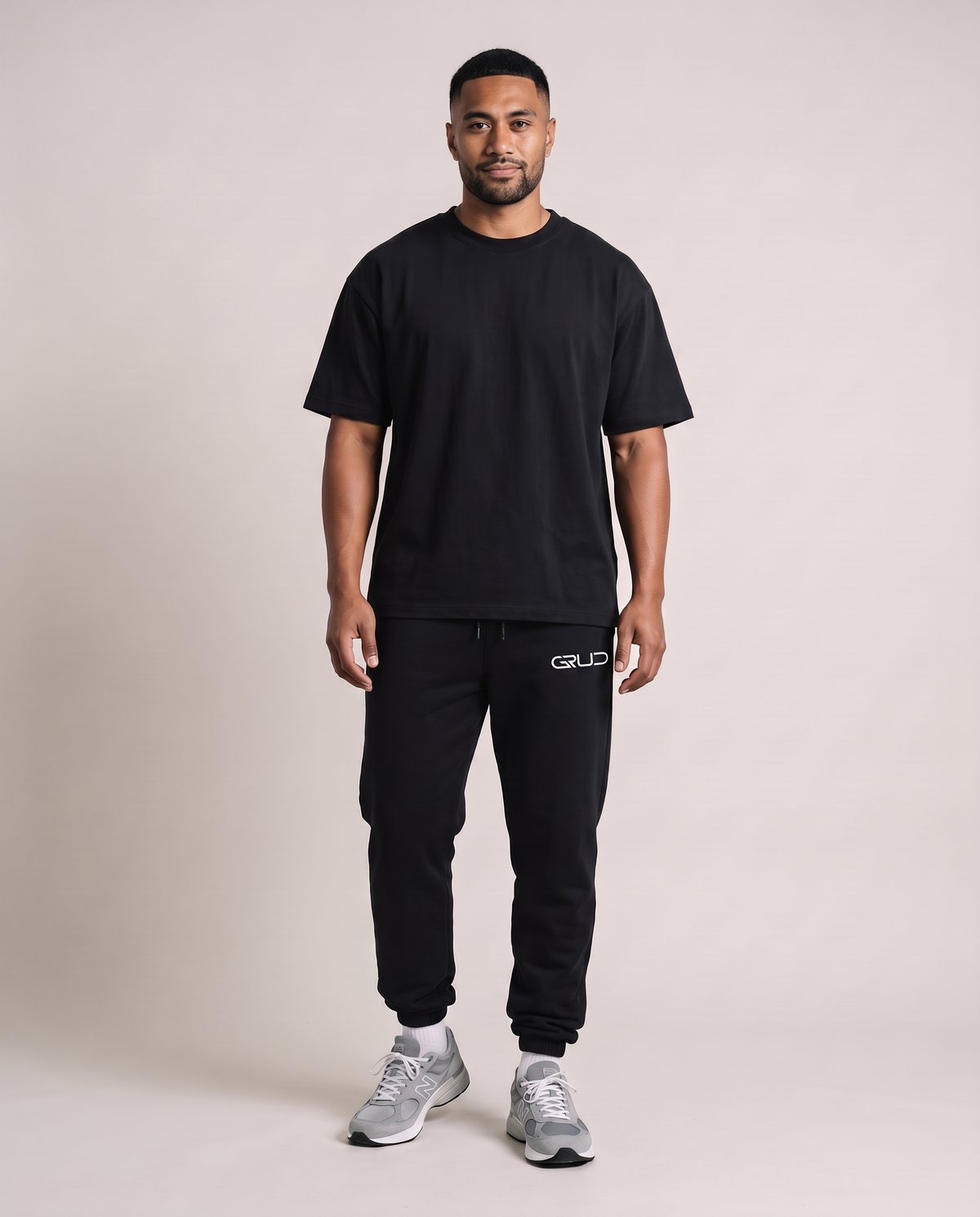 Model wearing the GRUD Essentials Sweat Pants in black with the Heavyweight Oversized Tee, front view