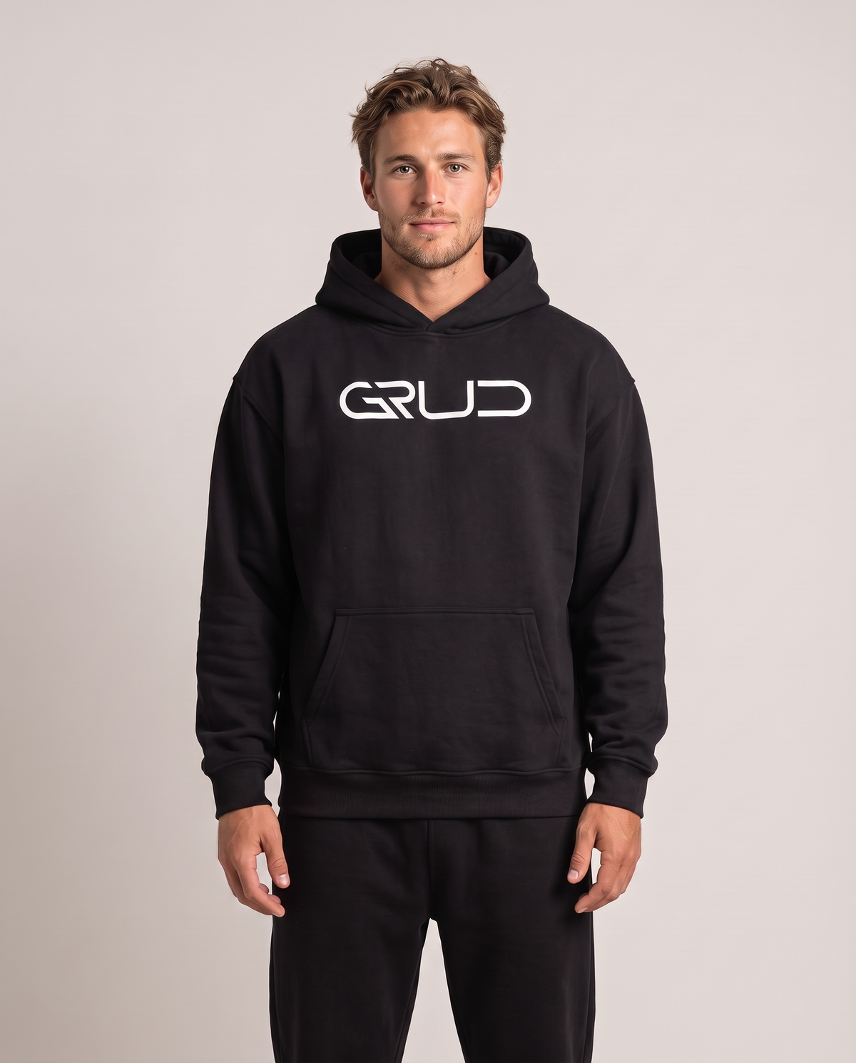 Model wearing the GRUD Heavyweight Hoodie in black, front view