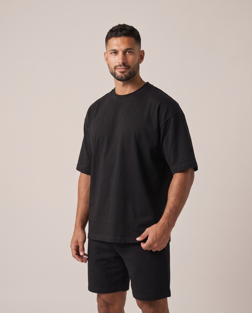 GRUD Heavyweight Oversized Tee in black, three-quarter view showing the dropped shoulders