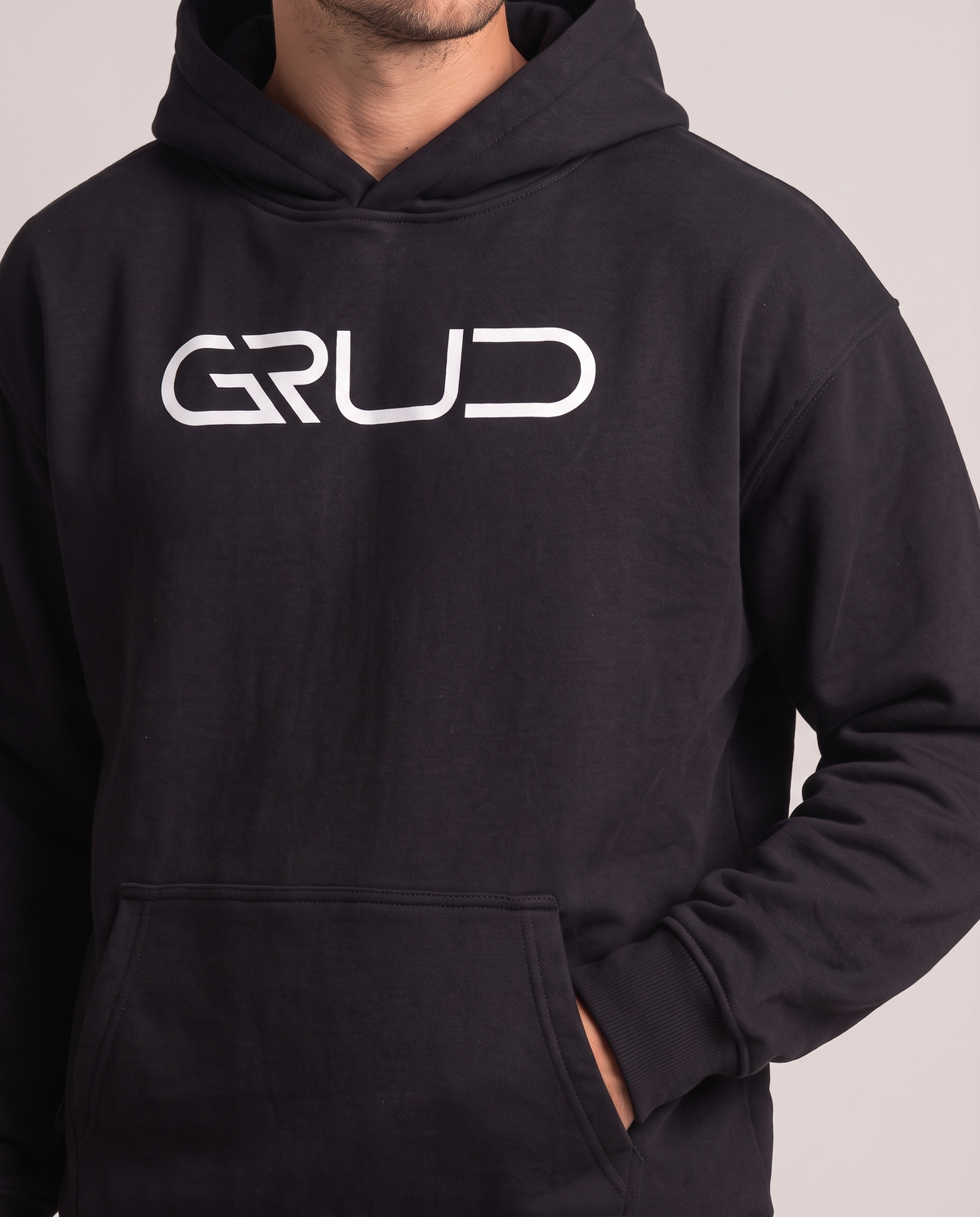GRUD Heavyweight Hoodie in black, close-up of the chest logo and heavyweight fleece