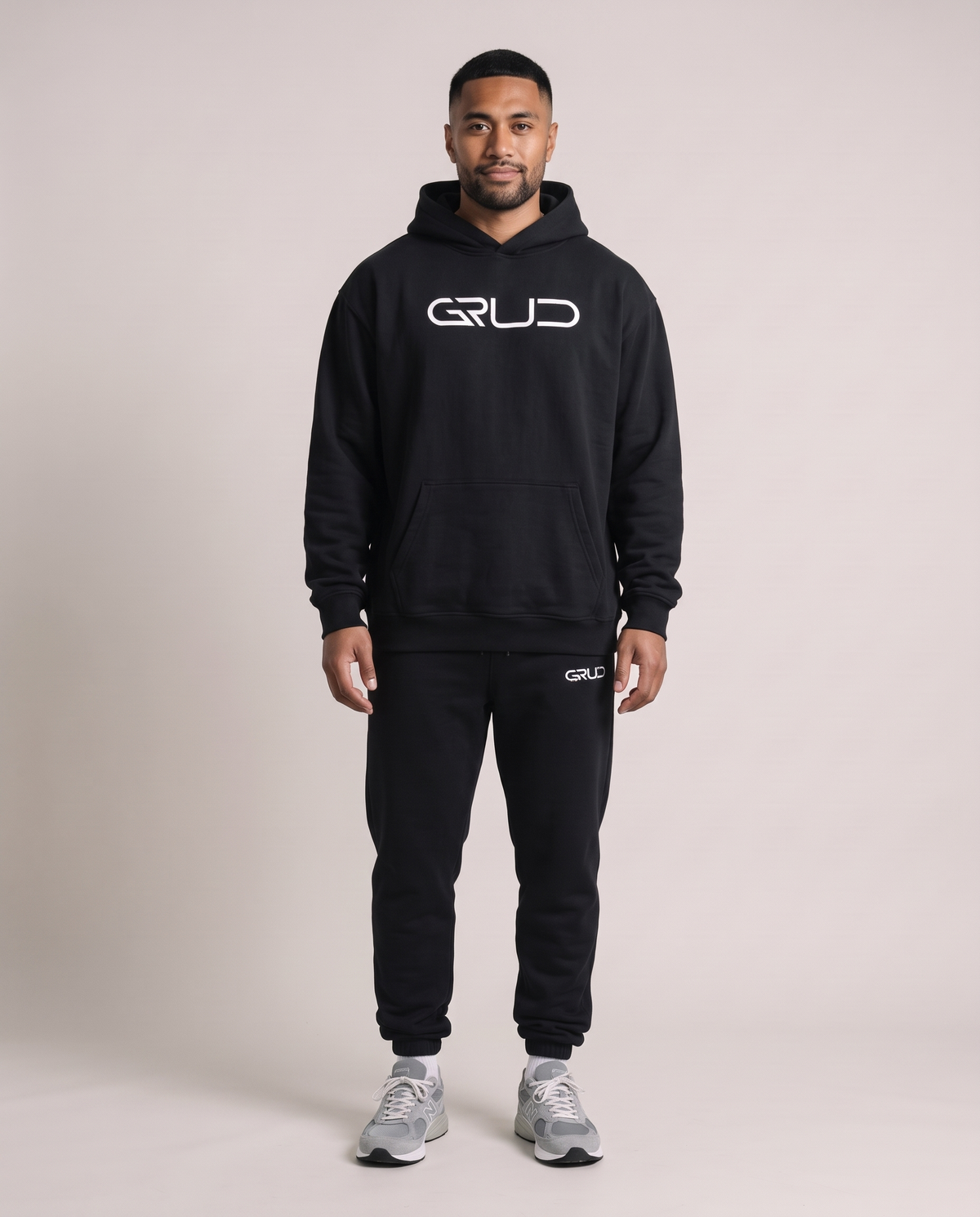 GRUD Heavyweight Hoodie and Essentials Sweat Pants in black on a broader build, front view