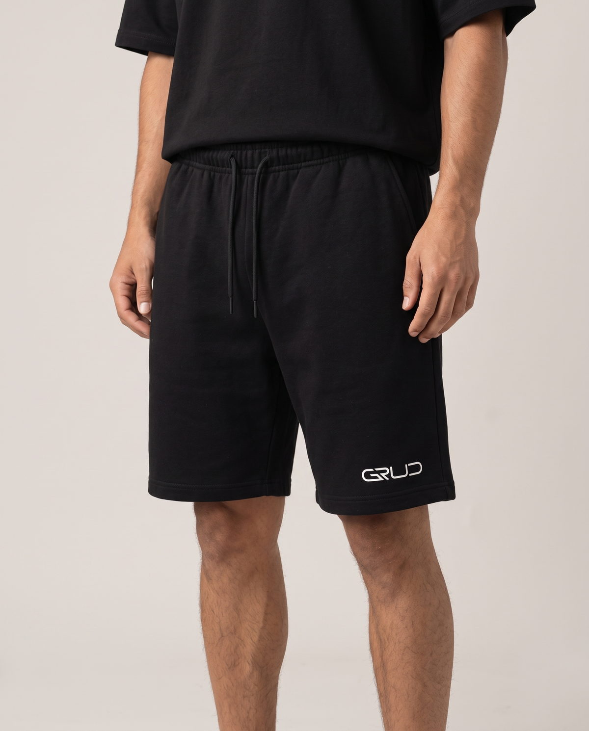 GRUD Oversized Shorts in black, close-up of the drawcord waist and fleece