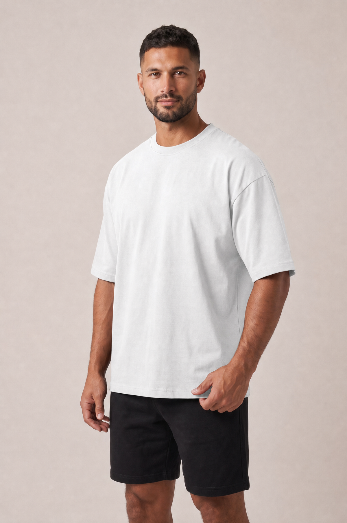 Model wearing the GRUD Heavyweight Oversized Tee in white, three-quarter view showing the dropped shoulders