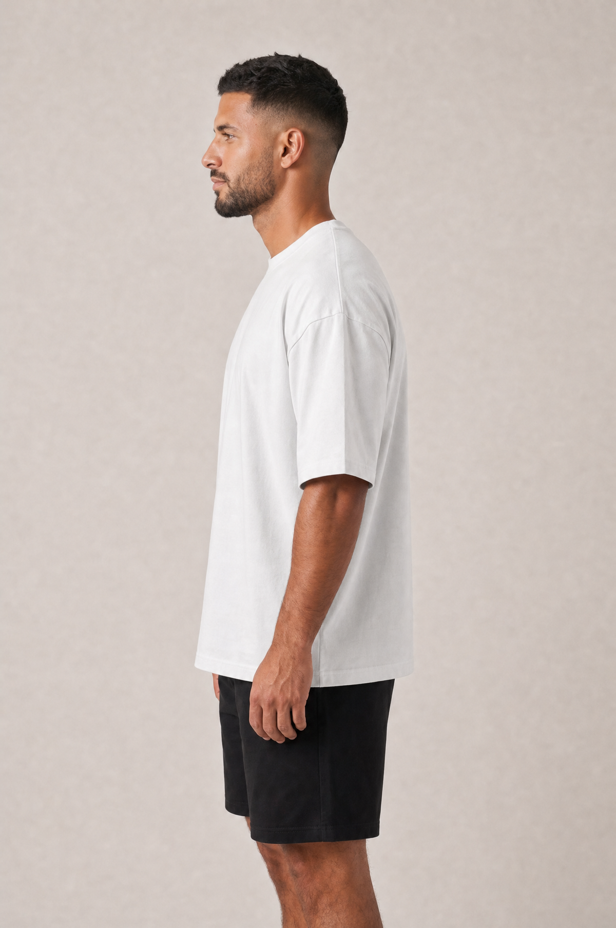 Model wearing the GRUD Heavyweight Oversized Tee in white, side view showing the dropped shoulder