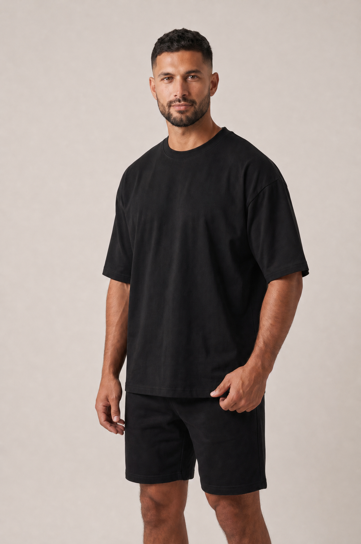 Model wearing the GRUD Heavyweight Oversized Tee in black, three-quarter view showing the dropped shoulders